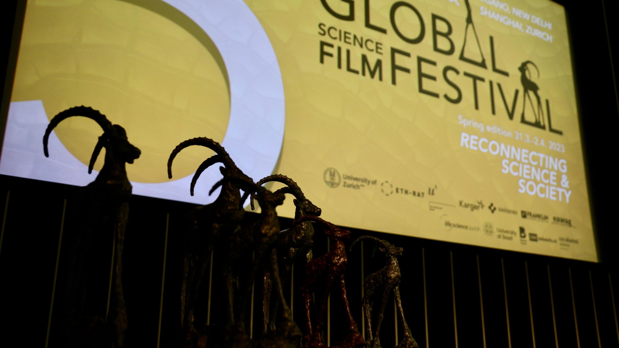 Global Science Film festival poster and Ibexes, trophies awarded to the winners © Swiss Science Film Academy