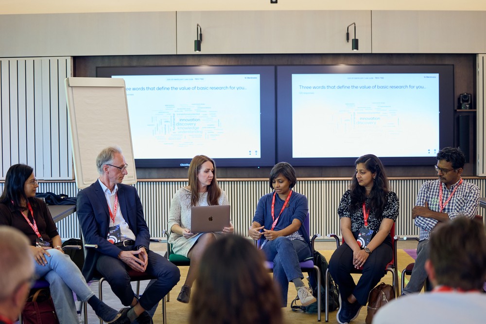 Participants discussing the value of basic research in infectious disease prevention and cure at the Swiss Re Centre for Global Dialogue