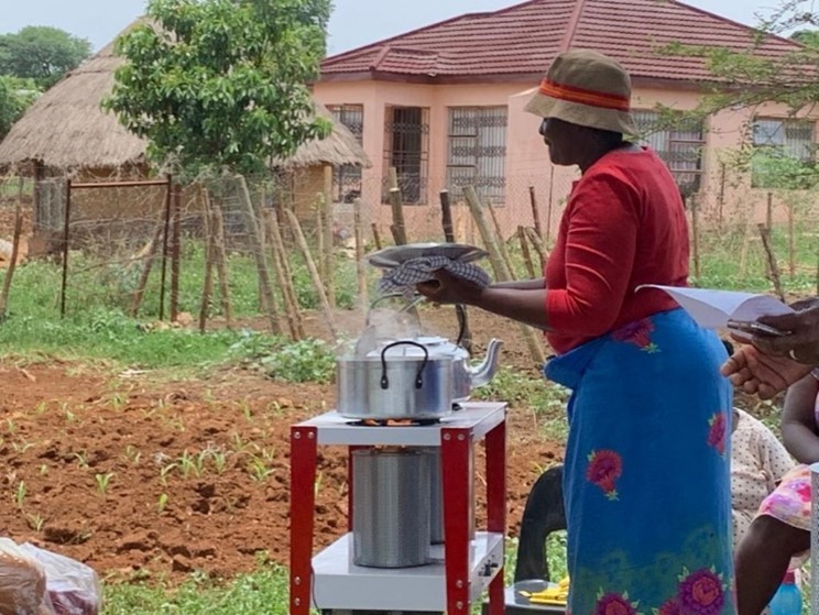 A member of the Mukomaasinandu village community tests the clean cooking stove