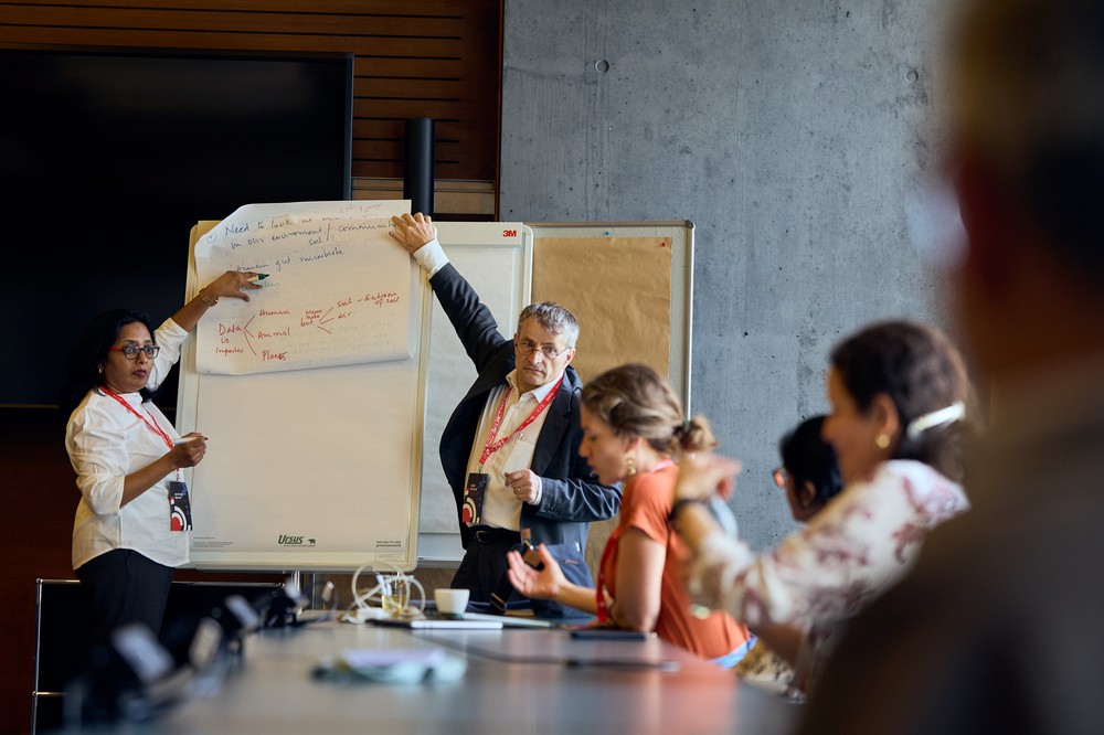 Dr. Joy Sarojini Michael (CMC Vellore) and Prof. Jakob Zinnstag (Swiss Tropical and Public Health Institute) and participants present the key findings after engaging in an inter-disciplinary workshop at the AMR Dialogue