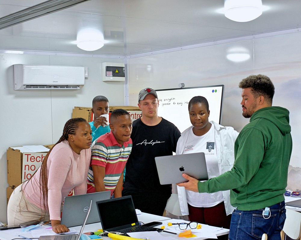 The InCube participants in the cube with facilitator Christian Pierce.